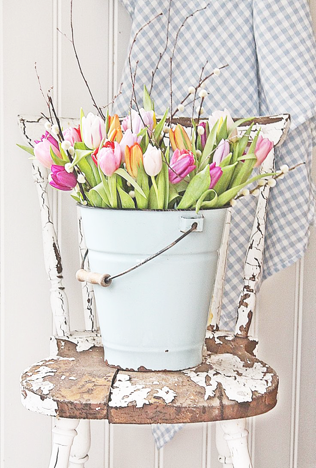 Spring flowers in a blue bucket