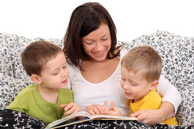 Mother reading book to kids